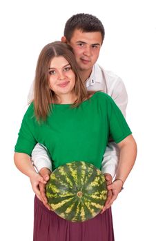 A man and a pregnant woman are holding a large watermelon in their hands. isolated on white background.