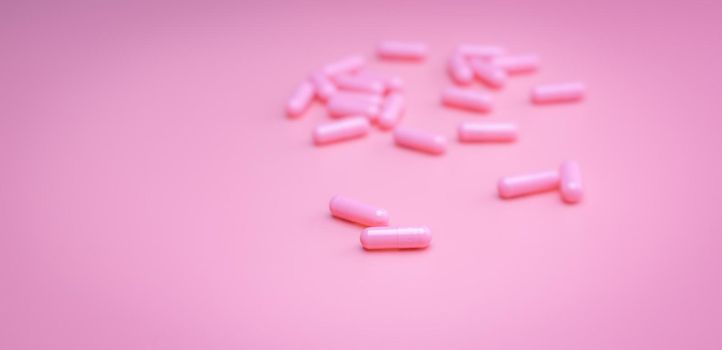 Pink capsules pill on pink background. Vitamins and supplements. Online pharmacy. Pharmacy store banner. Pharmaceutical industry. Woman's health insurance concept. Pills for love and happy life.
