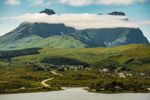 Lofoten Archipelago Villages. Nordland County, Norway. Scenic Two Peaks Covered by a Cloud.