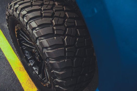 Performance Off Road Tires and Alloy Wheels Close Up Photo. Automotive Theme.