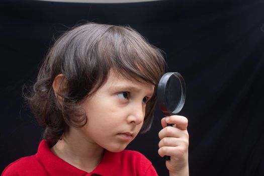 boy with magnifying glass ready to explore