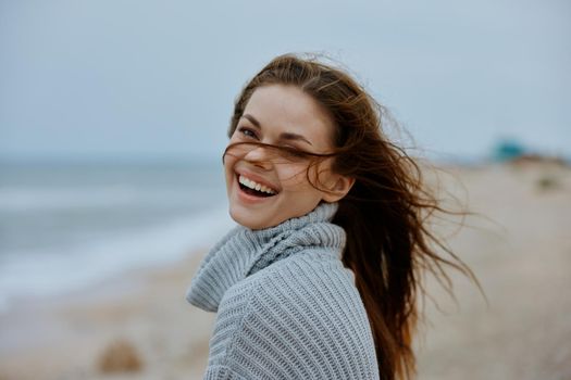 cheerful woman with long hair on the beach nature landscape walk Lifestyle. High quality photo