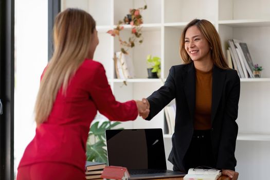 Estate agent and customer shaking hands after finished contract after about home insurance and investment loan.