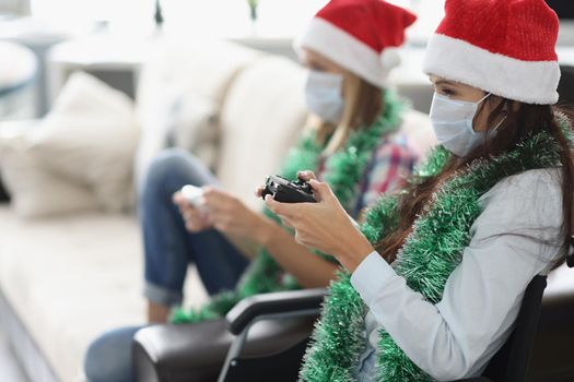 Portrait of friends have fun and playing video game using controlling joystick. Go nuts in hospital, celebrating new year. Healthcare, disabled concept