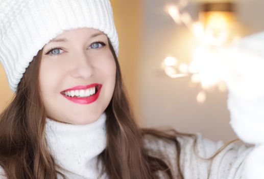 Christmas, people and winter holiday concept. Happy smiling woman wearing white knitted hat as closeup face xmas portrait.