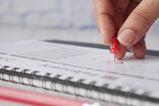 deadline concept with push pin on calendar date close up .