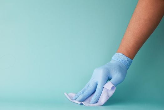close up of person hand cleaning table with cloth .
