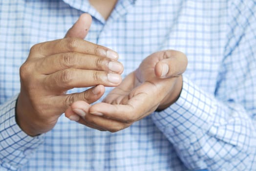 close up of young man hand using sanitizer gel for preventing virus.