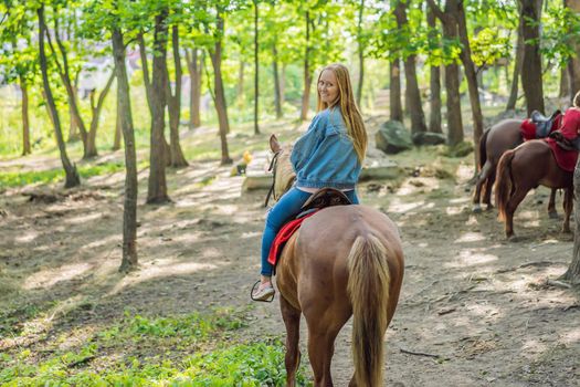 Beautifulwoman riding a horse in countryside.