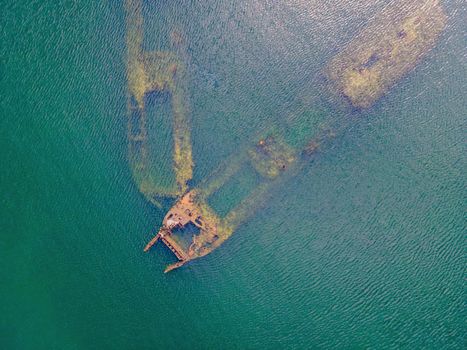 Abandoned broken shipwreck sticking out of the sea.