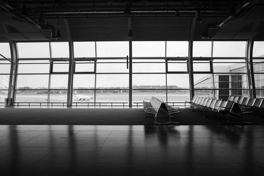 Deserted airport terminal. Rows of empty seats in the waiting room.