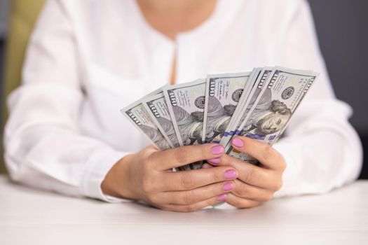 Woman counting dollar bills. Close up of female hands count money cash. Money calculation. Employee salary. Cash money payment Successful business concept. American currency exchange in bank