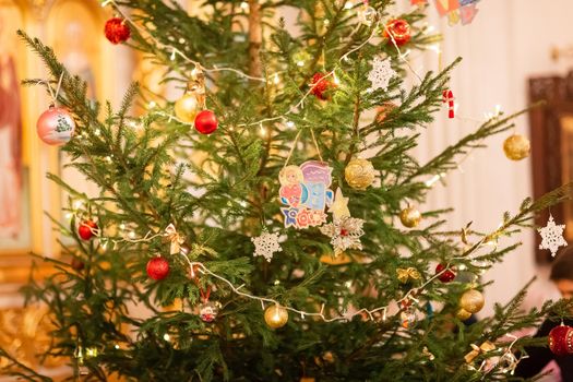 Decorated Christmas tree in Orthodox church on Christmas eve. Religious Christmas celebration concept