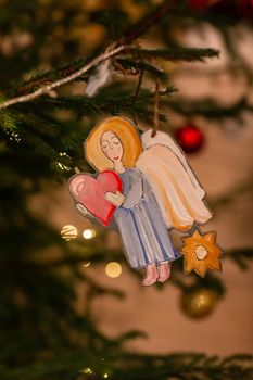 Decorated Christmas tree, angel in Orthodox church on Christmas eve. Religious Christmas celebration concept