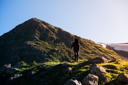 hikers with backpacks and trekking poles walking in Turkish highland