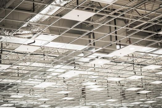 Ceiling Grid and HVAC Installation Inside Commercial Building. Construction Industry Theme.