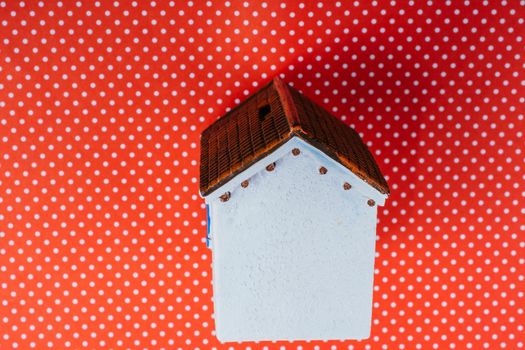 Little model house  on a color background in the view