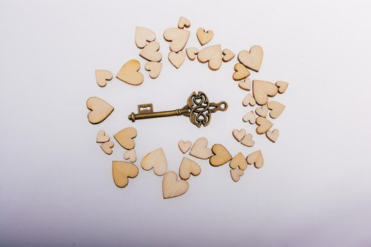 Retro  style heart shaped key on wooden hearts