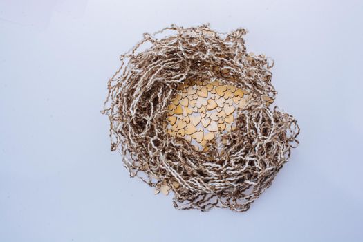 Wooden hearts form a round shape on white background