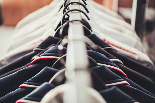 Colourful Apparel on a Rack Inside Boutique Store Close Up. Business Theme.