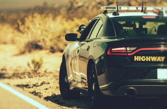 California Highway Patrol Cruiser on Side of a Desert Highway. United States of America. Police Theme.