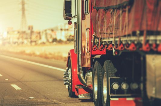 Speeding Red Semi Truck on a Nevada State Highway. United States of America. Transportation and Freight Industry Theme.