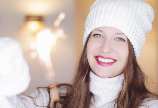 Christmas, people and winter holiday concept. Happy smiling woman wearing white knitted hat as closeup face xmas portrait.