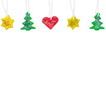 Garland with DIY Christmas tree, star and heart made from red, yellow and green Plasticine. Christmas or New Year banner with copy space. Plasticine craft concept.