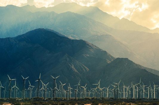 California Desert Wind Turbines in Coachella Valley. Scenic Mountains and Sun Light. California, United States.