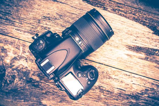 Professional 35mm Digital Camera on Wooden Table. Top View.