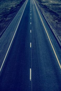 Empty Straight Two Lanes Highway From Above. Fresh Highway Pavement. Dark Blue Color Grading.