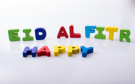 the word EID EL FITR  written with colorful letter blocks