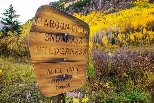 Maroon Bells Snowmass Wilderness - White River National Forest Wooden Sign near Maroon Bells, Aspen, Colorado, United States.