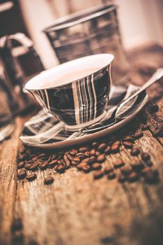 Coffee and Beans. Elegant Tartan Design Coffee Cup and Coffee Beans on Wooden Table.