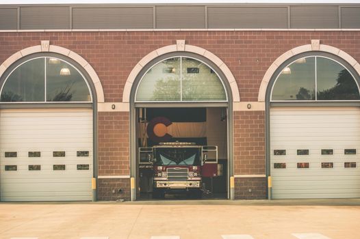 Firefighters of Colorado. Fire Truck inside Firehouse. Large Colorado Flag on the Wall. Colorado Fire Department.