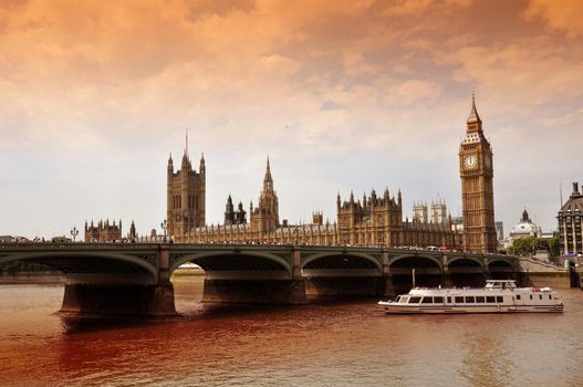 Westminster Bridge with Big Ben and the Houses of Parliament, London, United Kingdom (UK). Thames River and Touristic Boat. Horizontal Photography.