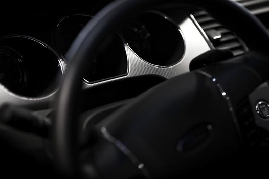 Car Steering Wheel and Dark Black Interior - Vehicle Dashboard. Closeup Photography