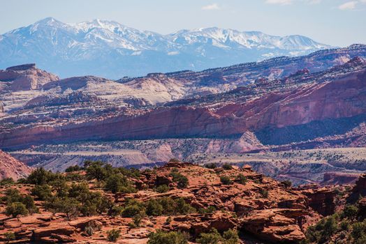 Colorful Utah Landscape. Red Sandstones In the Front and Snowy Mountains in the Back. Capitol Reef National Park. South Central Utah State.
