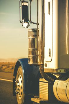 Semi Truck Tractor Closeup on the Highway in Vertical Photography.