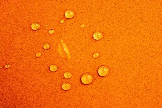 Round water drops in  close-up view  on colorful background