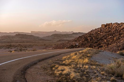 Utah Desert Road at Sunset. Raw Rocky Landscape. Utah, United State.