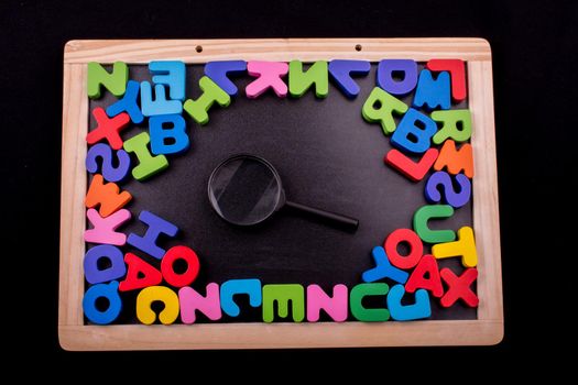 Magnifying glass and Colorful Letters of Alphabet