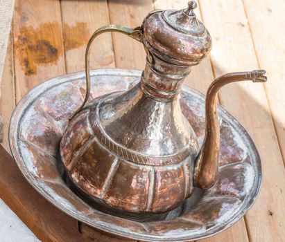 Ancient metal jug in oriental style  in antique market