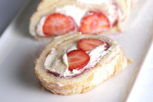 A fresh strawberry and cream roularde swiss roll