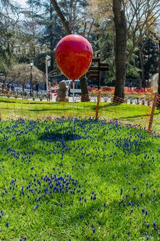 Decorative colorful balloons in the flower garden