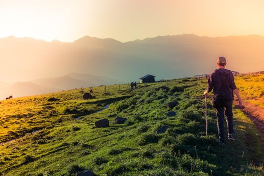 hikers with backpacks and trekking poles walking in Turkish highland