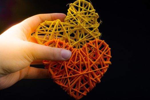 Handmade straw heart or valentines day object in hand