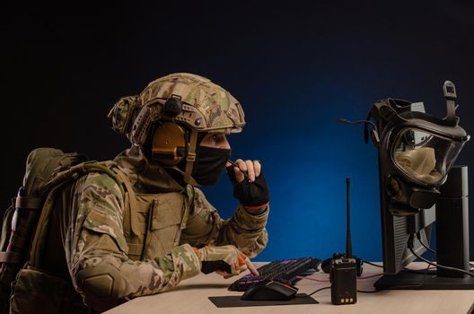 soldier sitting at a computer is conducting a cyber war