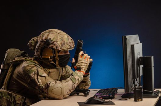 soldier sitting at a computer is conducting a cyber war