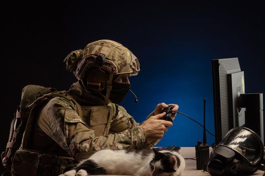 soldier sitting at a computer is conducting a cyber war